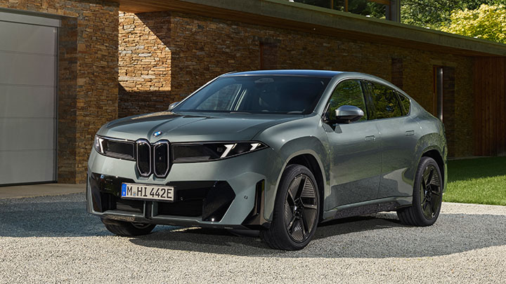 BMW iX4 front static outside house