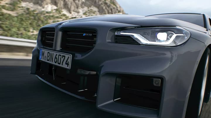 Close up shot of a grey BMW M2's front bumper