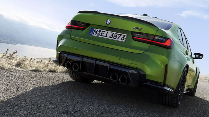 Stationary rear shot of a green BMW M3 Competition