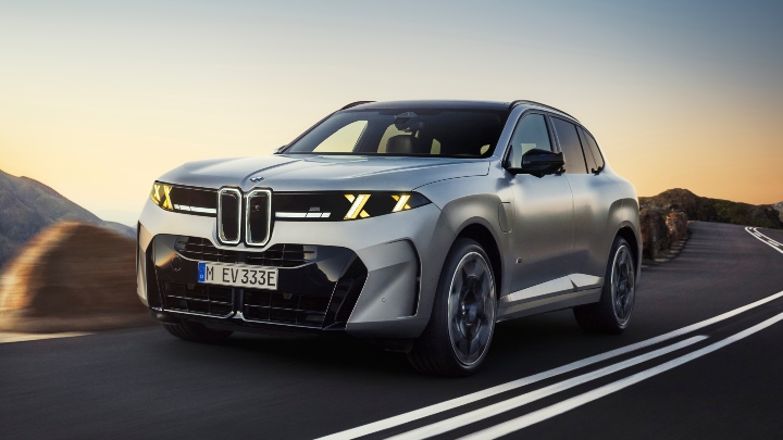 Silver BMW X5 driving front 