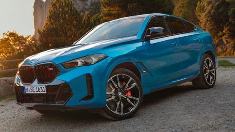Blue BMW X6 parked on a country road
