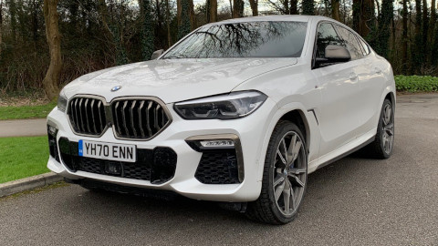 White BMW X6 M50d Exterior Front Static in Front of Trees