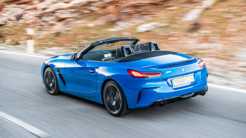 Blue BMW Z4 Exterior Rear Driving on Road with Rocky Terrain in the Background