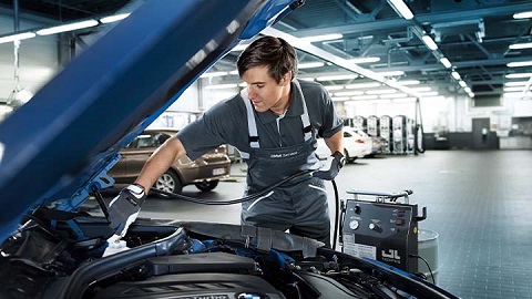 bmw technician performing air conditioning service