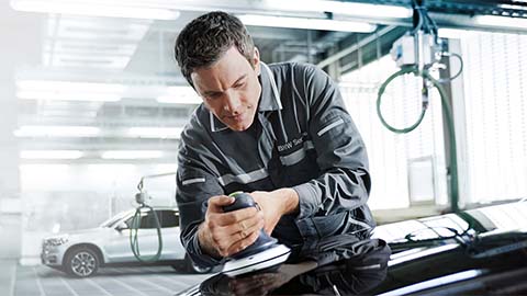 technician polishing bmw bonnet