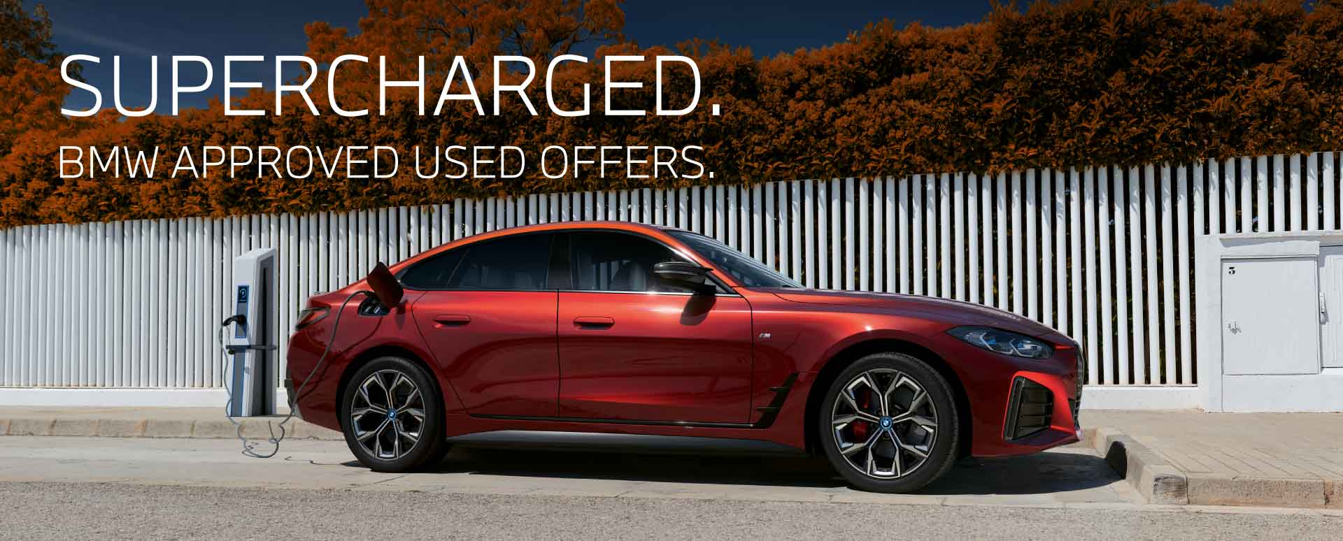 red BMW vehicle on charge parked