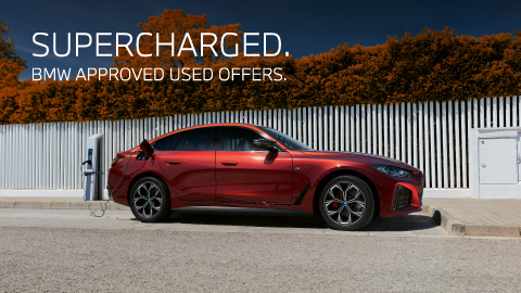 red BMW vehicle on charge parked