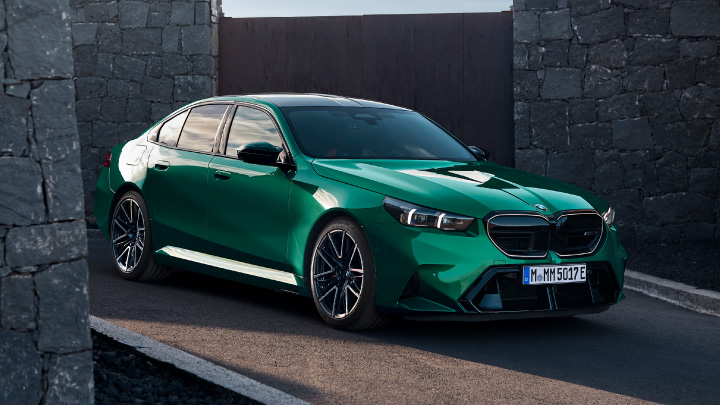 Metallic Green BMW Vehicle Driving Down Ramp