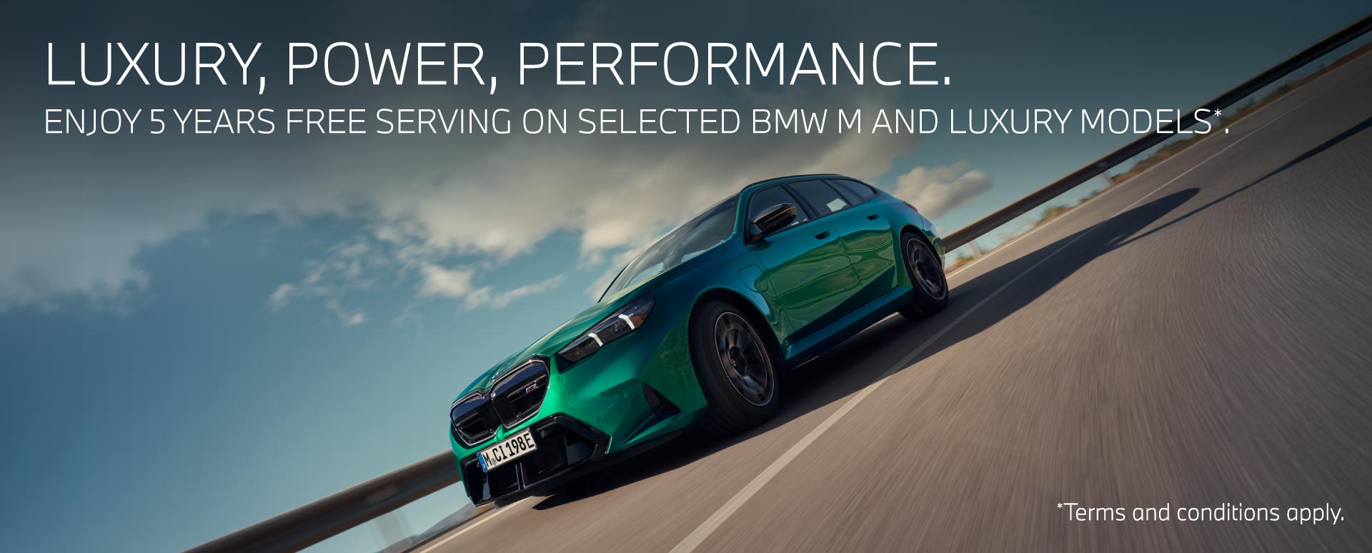 Green BMW M car travelling on the road. BMW promotion.