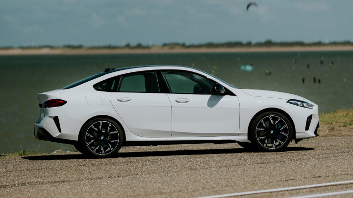 White BMW Parked Sideways By Beach