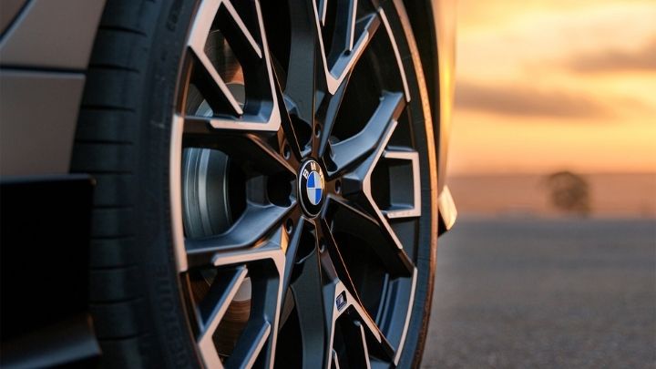 BMW wheel with a sunset in the background