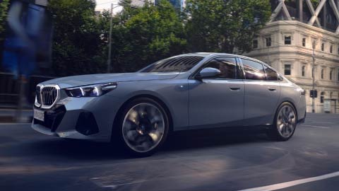 Side Shot of Grey BMW i5 Driving