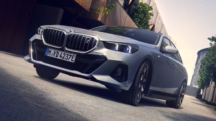 Front Shot of Grey BMW i5 Driving