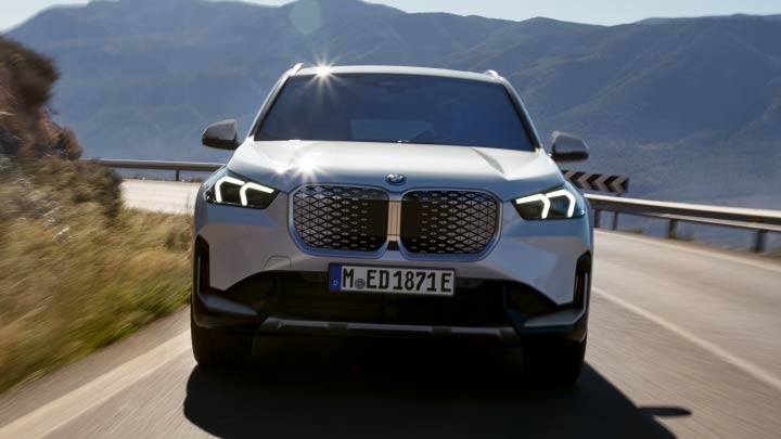 White BMW iX1 Driving On Mountain Road