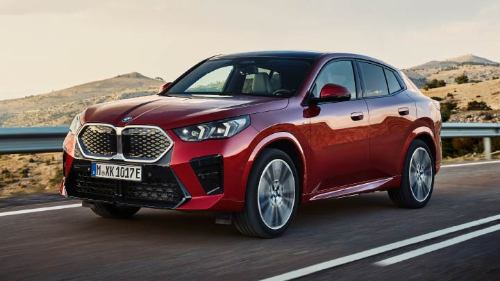 Red BMW iX2 Driving On Mountain Road