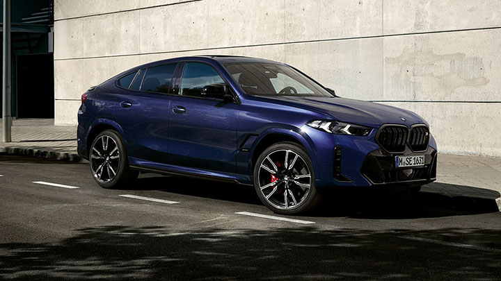 Blue BMW X6 M Competition parked on the road