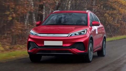 Red BYD ATTO 3, driving in the countryside