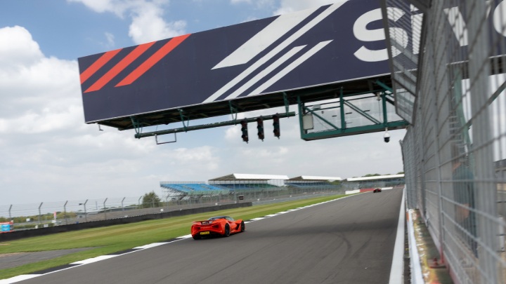 Orange Lotus Evija Exterior Rear Driving at Silverstone