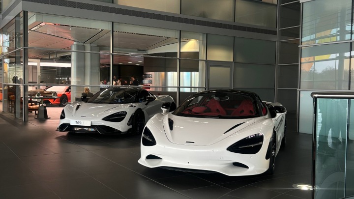Duo of White McLaren models inside McLaren Factory