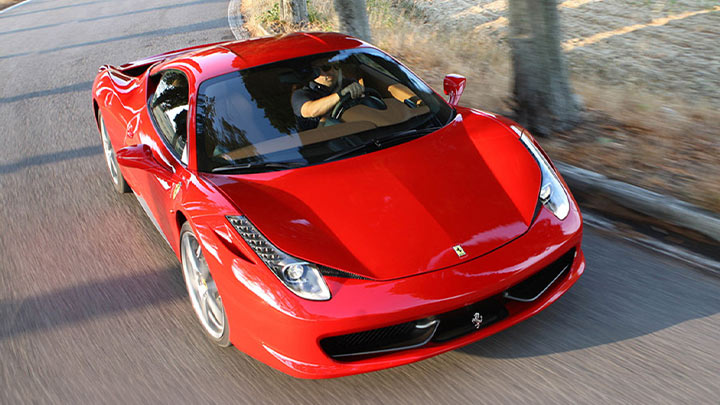 Aerial driving shot of a red Ferrari 458