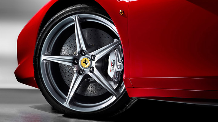 Close up of a red Ferrari 458's alloy wheel and brake caliper