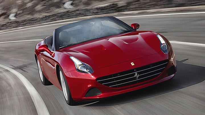 Front aerial shot of a driving red Ferrari California