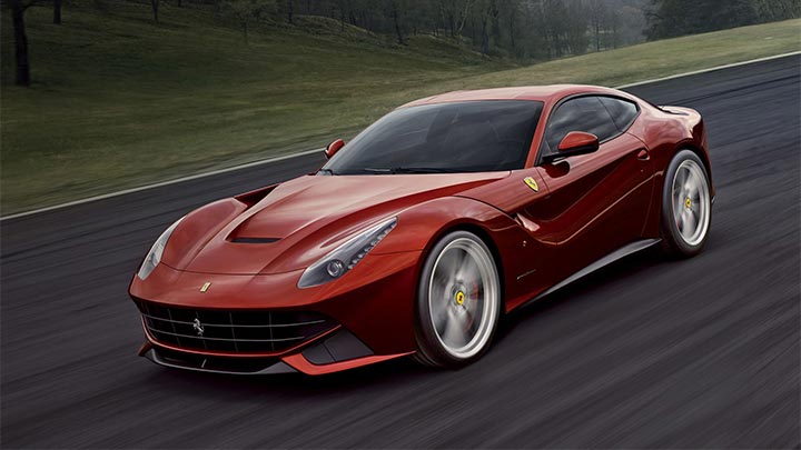 Front quarter shot of a driving red Ferrari F12 Berlinetta