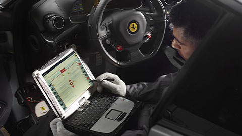 Ferrari Technician completing diagnostics on a Ferrari