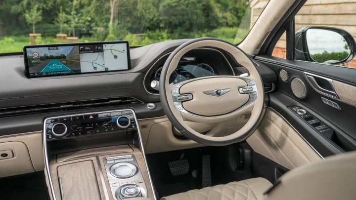 Cream Genesis GV80 interior with focus on steering wheel