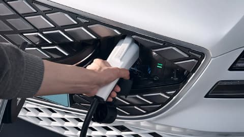 Close up of a white Genesis GV80 being placed on charge