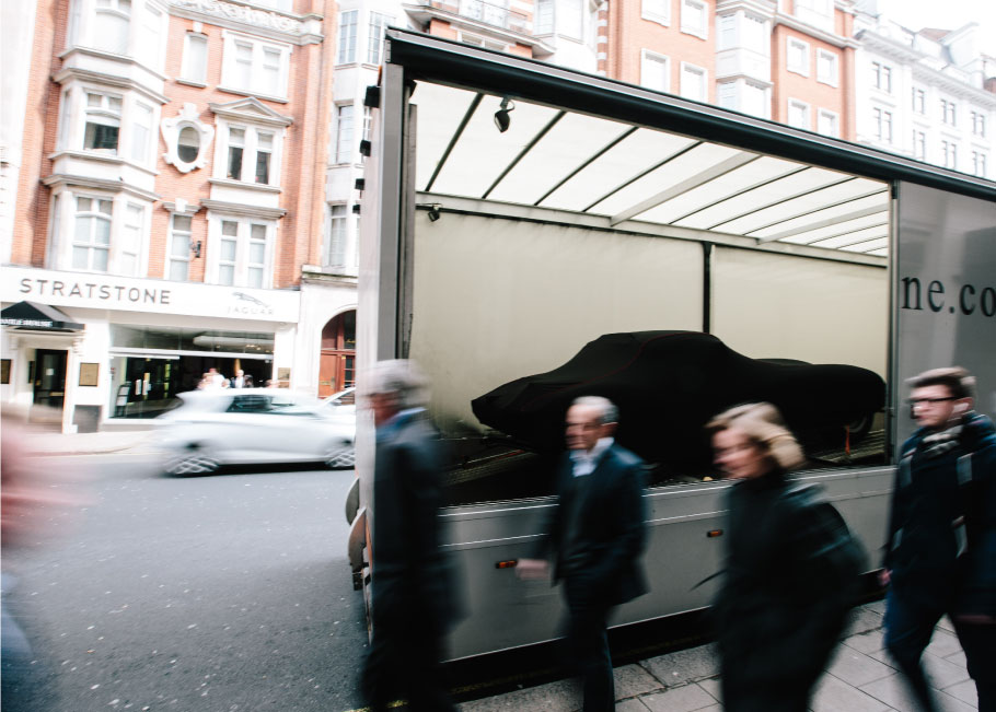 People walking past the Lightweight E-Type.