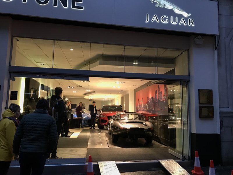 Crowds gather round the E-Type.