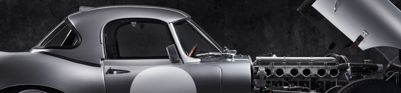 E-Type with the bonnet open showing the engine.