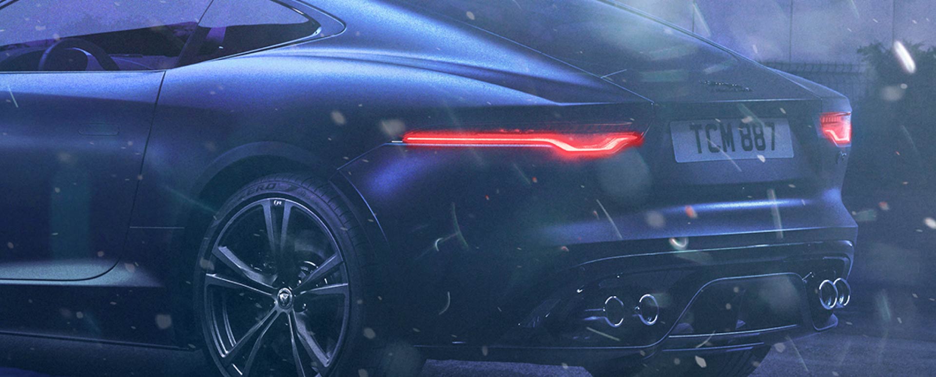 Rear of black Jaguar vehicle in winter.