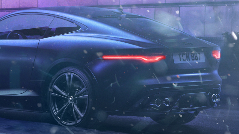 Rear of black Jaguar vehicle in winter.