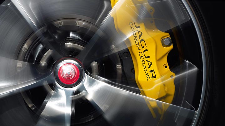 yellow Jaguar brake caliper behind alloy wheel