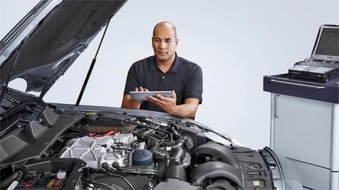 technician inspecting jaguar engine bay