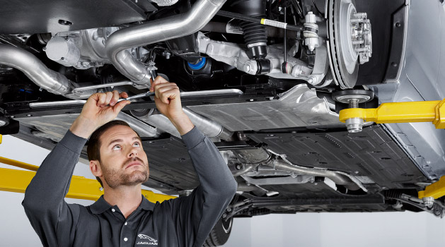 Vehicle technician working under a car.