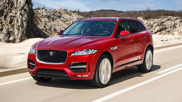Red Jaguar F-PACE Driving On Road