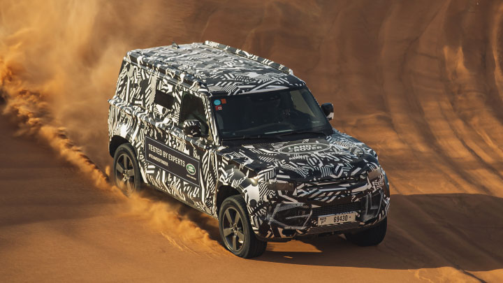 Land Rover Defender wrapped in camouflage. 