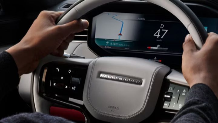 Man holding a Land Rover's steering wheel