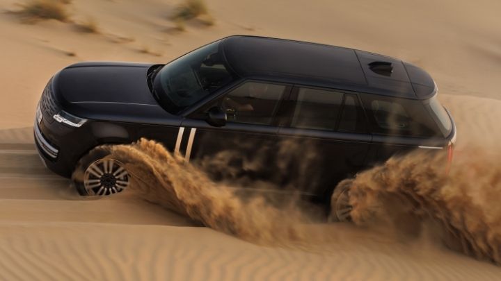 Range Rover Electric being driven in the dunes