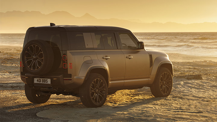 Rear shot of silver Land Rover Defender Octa parked