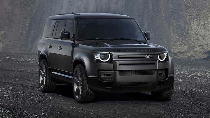 Black Land Rover Defender 130 render shot with mountain in background