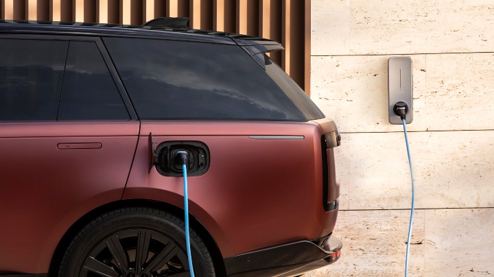 Range Rover SV plugged in and charging at a wall-mounted home charger