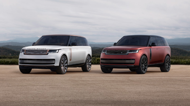 Two Range Rover SV luxury SUVs parked side by side in contrasting exterior colours