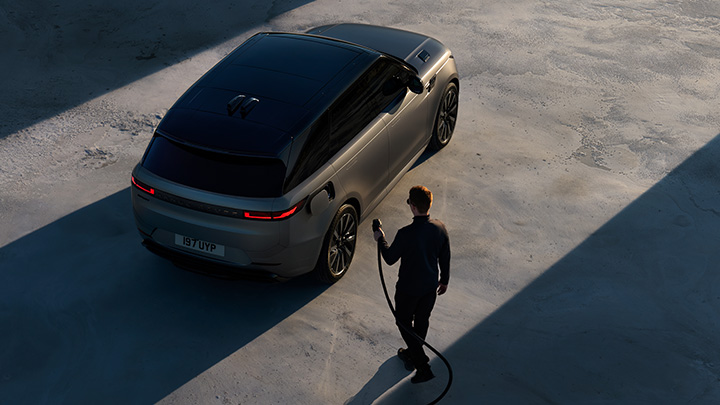 Range Rover Sport Electric with person plugging in