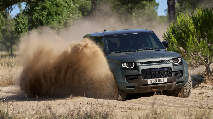 Land Rover Defender driving in sand