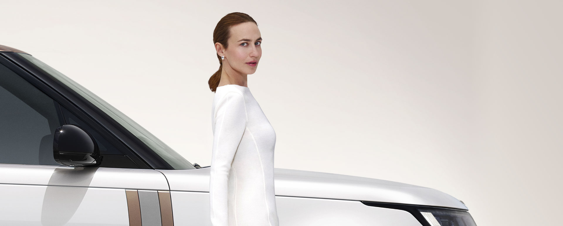 woman in front of Land Rover vehicle