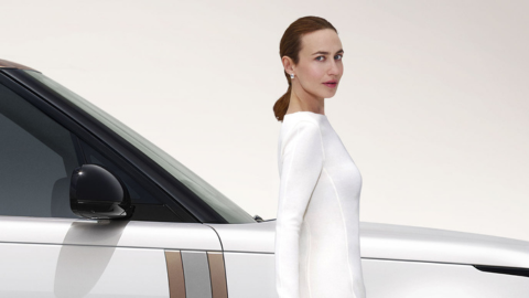 Woman in White Stood in Front of Range Rover Side View